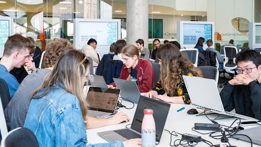 Students on laptops in a classroom setting
