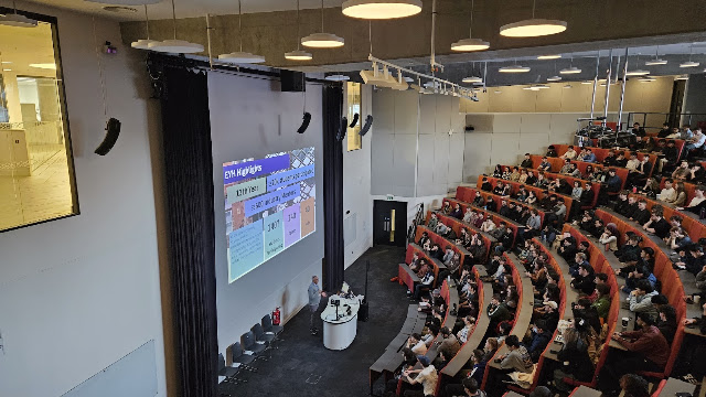people in a large lecture theatre